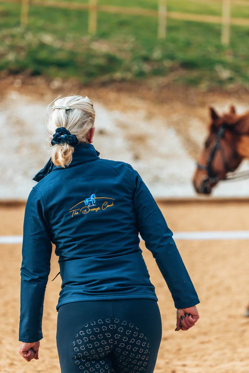 A dressage rider riding a dressage horse in a dressage coaching session